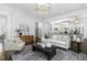 Open concept living room with hardwood floors, stylish lighting, and seamless flow to the kitchen at 543 Guilford Cir, Raleigh, NC 27608