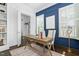 Office with blue accent wall, plantation shutters, and bright light at 543 Guilford Cir, Raleigh, NC 27608