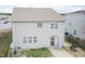 View of the home's rear exterior with sliding glass doors and a modest backyard at 6100 Paducah Dr, Raleigh, NC 27610