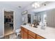 Light-filled bathroom featuring a double vanity, large mirror, and walk-in closet at 6100 Paducah Dr, Raleigh, NC 27610
