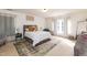 Bright and cozy bedroom with natural light, neutral decor, and comfortable furnishings at 6100 Paducah Dr, Raleigh, NC 27610