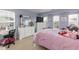 Well-lit bedroom with a white dresser, mirror, and view of the neighborhood at 6100 Paducah Dr, Raleigh, NC 27610