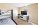 Neutral bedroom with bunkbeds, a dresser, and a view to the outside at 6100 Paducah Dr, Raleigh, NC 27610