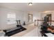 Spacious bonus room with gym equipment, natural light, and modern finishes at 6100 Paducah Dr, Raleigh, NC 27610