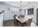 Dining area with elegant chandelier, tile floors and sliding glass doors at 6100 Paducah Dr, Raleigh, NC 27610
