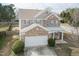 Inviting two-story home featuring brick accents, neutral siding, an attached garage, and manicured landscaping at 6100 Paducah Dr, Raleigh, NC 27610