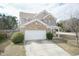 Desirable two-story home showcasing a brick facade, an attached garage, and a beautifully landscaped front yard at 6100 Paducah Dr, Raleigh, NC 27610