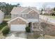 Attractive two-story home with a brick and siding exterior, a well-maintained lawn, and an attached two-car garage at 6100 Paducah Dr, Raleigh, NC 27610