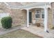 Inviting front porch with seating, brick accents, and a stylish entryway, perfect for relaxing outdoors at 6100 Paducah Dr, Raleigh, NC 27610