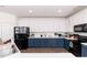 Spacious kitchen features two-tone cabinets, modern appliances, and ample counter space at 6100 Paducah Dr, Raleigh, NC 27610