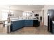 Kitchen area with stylish blue cabinets, modern sink and stainless steel appliances at 6100 Paducah Dr, Raleigh, NC 27610