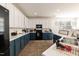 Well-lit kitchen featuring two-tone cabinetry, modern appliances, and a view from the sink at 6100 Paducah Dr, Raleigh, NC 27610