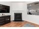 Living room featuring a cozy fireplace and a view through to another room at 6100 Paducah Dr, Raleigh, NC 27610