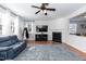 Cozy living room featuring a fireplace, ceiling fan and bright windows at 6100 Paducah Dr, Raleigh, NC 27610