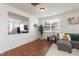 Bright living room with hardwood floors, large window and comfortable gray sectional sofa at 6100 Paducah Dr, Raleigh, NC 27610