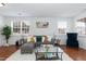Stylish living room featuring modern decor, a comfortable sectional sofa, and bright natural light from large windows at 6100 Paducah Dr, Raleigh, NC 27610