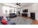 Inviting living room with fireplace, hardwood floors, plush rug, and ample natural light at 6100 Paducah Dr, Raleigh, NC 27610