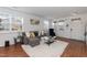 Inviting living room with bright windows, featuring a plush sectional sofa, a modern coffee table, and a cozy rug at 6100 Paducah Dr, Raleigh, NC 27610