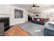 Open-concept living room featuring a fireplace, wood floors, and seamless access to the kitchen at 6100 Paducah Dr, Raleigh, NC 27610