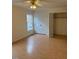Bright bedroom featuring hardwood floors, a ceiling fan, a window, and a spacious closet for ample storage at 6102 Highcastle Ct, Raleigh, NC 27613