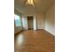 Bedroom featuring hardwood floors, a ceiling fan, a window, and a spacious closet for ample storage at 6102 Highcastle Ct, Raleigh, NC 27613
