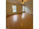 Large bedroom with natural light, wood floors, neutral paint, and spacious closet at 6102 Highcastle Ct, Raleigh, NC 27613