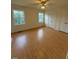 Bedroom with natural light, hardwood floors, ceiling fan, and closet for storage at 6102 Highcastle Ct, Raleigh, NC 27613