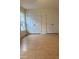 Bright bedroom featuring hardwood floors, a window, and two spacious closets for ample storage space at 6102 Highcastle Ct, Raleigh, NC 27613