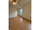 Spacious bedroom featuring warm, wood-look floors and a ceiling fan at 6102 Highcastle Ct, Raleigh, NC 27613