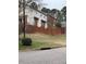 Exterior view of townhome featuring a well-manicured lawn with a fence at 6102 Highcastle Ct, Raleigh, NC 27613