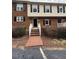 Charming brick townhouse with black shutters and a welcoming entryway staircase at 6102 Highcastle Ct, Raleigh, NC 27613