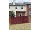 A townhome exterior with a brick facade and a private fenced-in backyard at 6102 Highcastle Ct, Raleigh, NC 27613