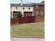 Townhome exterior showcases brick and siding with a fenced backyard on a grassy slope at 6102 Highcastle Ct, Raleigh, NC 27613
