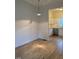 View of the kitchen with white cabinets and stainless steel appliances from living area at 6102 Highcastle Ct, Raleigh, NC 27613
