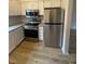 Modern kitchen featuring stainless steel appliances, granite countertops, and subway tile backsplash at 6102 Highcastle Ct, Raleigh, NC 27613