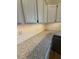 Close up of modern kitchen featuring white cabinets, granite countertops and subway tile backsplash at 6102 Highcastle Ct, Raleigh, NC 27613