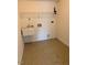 Laundry room with utility sink and shelving at 6102 Highcastle Ct, Raleigh, NC 27613
