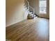 Cozy living room with light-colored wood floors and a staircase with white railings at 6102 Highcastle Ct, Raleigh, NC 27613