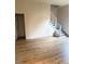Spacious living room featuring luxury vinyl flooring, stairs, and ample natural light at 6102 Highcastle Ct, Raleigh, NC 27613