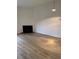 Bright living room with a cozy fireplace and modern light-colored wood floors at 6102 Highcastle Ct, Raleigh, NC 27613