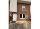 Townhome featuring a private patio with brick walls and a white entry door at 6102 Highcastle Ct, Raleigh, NC 27613