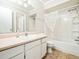 Bathroom featuring shower with curtain, large vanity and neutral tile flooring at 6469 New Market Way, Raleigh, NC 27615