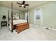 Spacious bedroom with a ceiling fan, carpet flooring, and a four-poster bed at 6469 New Market Way, Raleigh, NC 27615