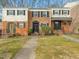 Charming townhomes featuring brick facades, black shutters, and well-maintained landscaping at 6469 New Market Way, Raleigh, NC 27615