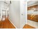 Hallway view to the kitchen and living area featuring hardwood flooring at 6469 New Market Way, Raleigh, NC 27615
