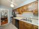 Kitchen with oak cabinets, black appliances, and a ceiling fan at 6469 New Market Way, Raleigh, NC 27615