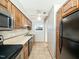 Kitchen with oak cabinetry, white countertops, and black appliances at 6469 New Market Way, Raleigh, NC 27615