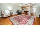 Bright living room featuring hardwood floors, neutral walls, columns and a dining table at 6469 New Market Way, Raleigh, NC 27615