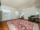 Living room featuring hardwood floors, neutral walls, and bright natural light at 6469 New Market Way, Raleigh, NC 27615