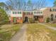 Exterior of multi-Gathering townhomes featuring brick and siding facades at 6469 New Market Way, Raleigh, NC 27615
